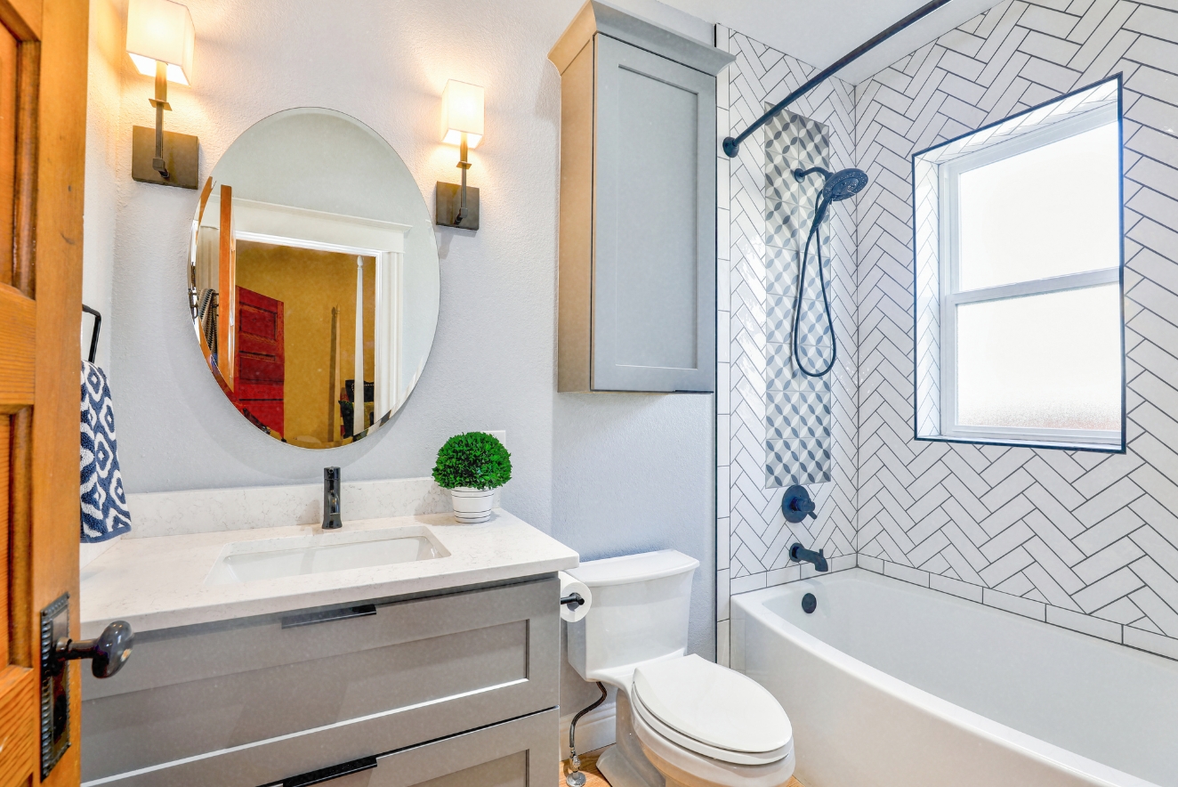 Home organization in a pristine bathroom featuring a well-organized vanity, clutter-free surfaces, and neatly arranged fixtures, showcasing effective use of space and storage.