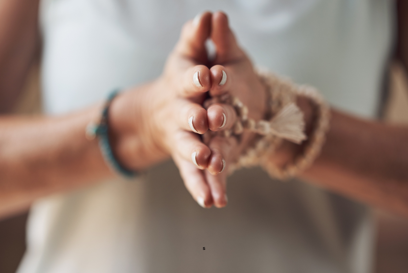 Hands in yoga mudra position, symbolizing holistic health practices for mind-body connection