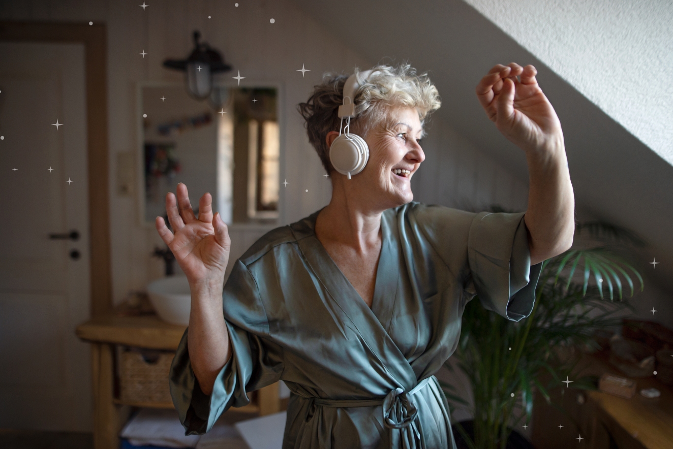 Senior woman practicing holistic health through joyful dance and music therapy at home