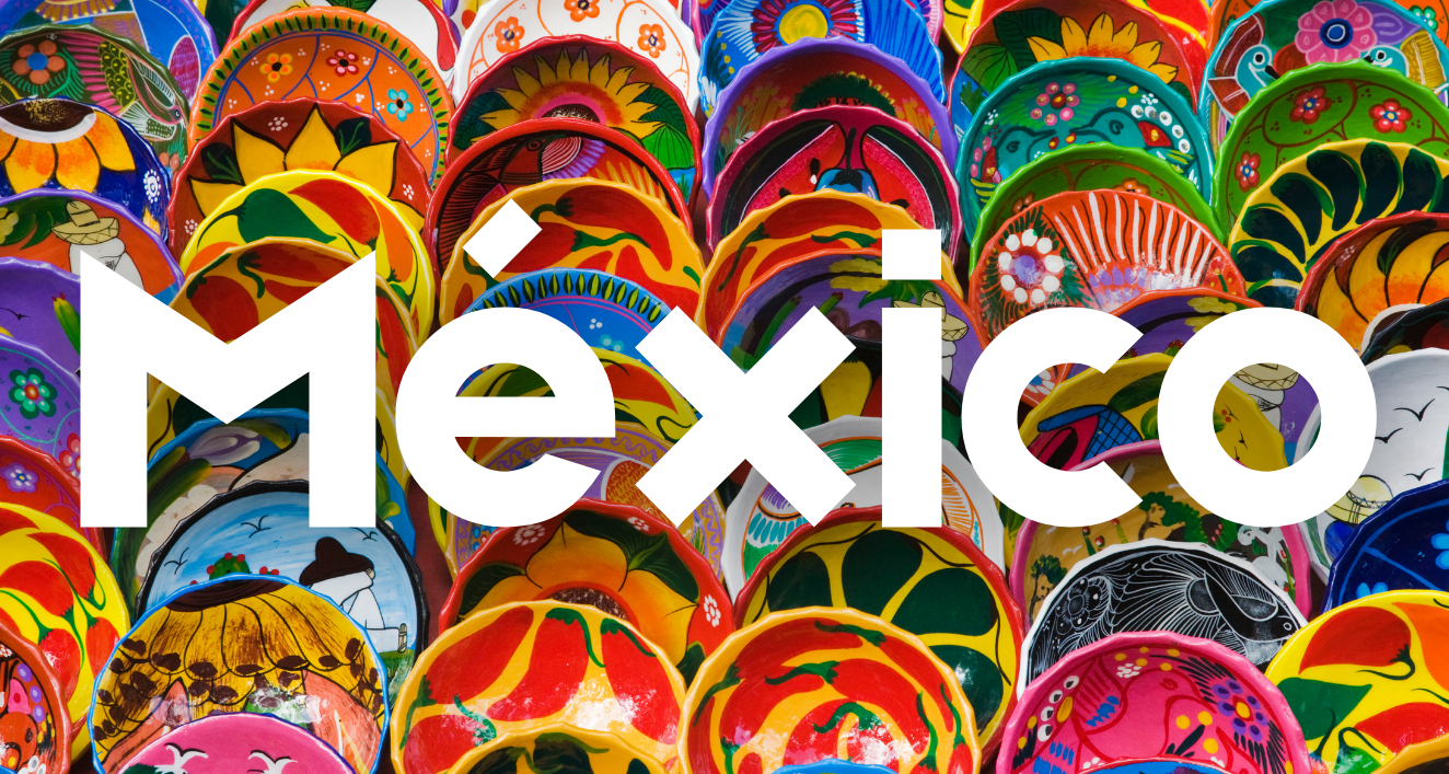 This image shows a vibrant collection of colorful Mexican ceramic plates and pottery arranged together, with the word "Mexico" prominently displayed in white text overlaid on the ceramics. The traditional pottery features bright patterns in yellow, red, green, blue, and orange with various designs including stars, flowers, and geometric patterns. This visual representation highlights Mexico's rich artistic heritage and traditional craftsmanship in ceramics.